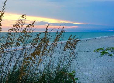 View from Ocean's Reach on Sanibel Island looking out over a sunset from a beachfront condo