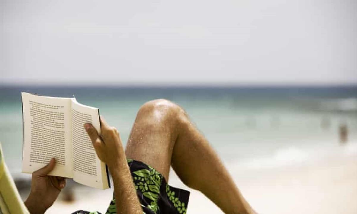 Man reading on the beach